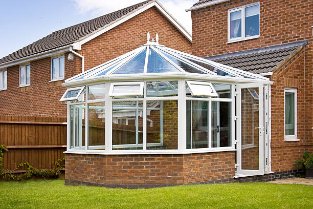 exterior view of conservatory attached to red brick house